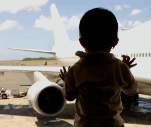 boy looking at plane